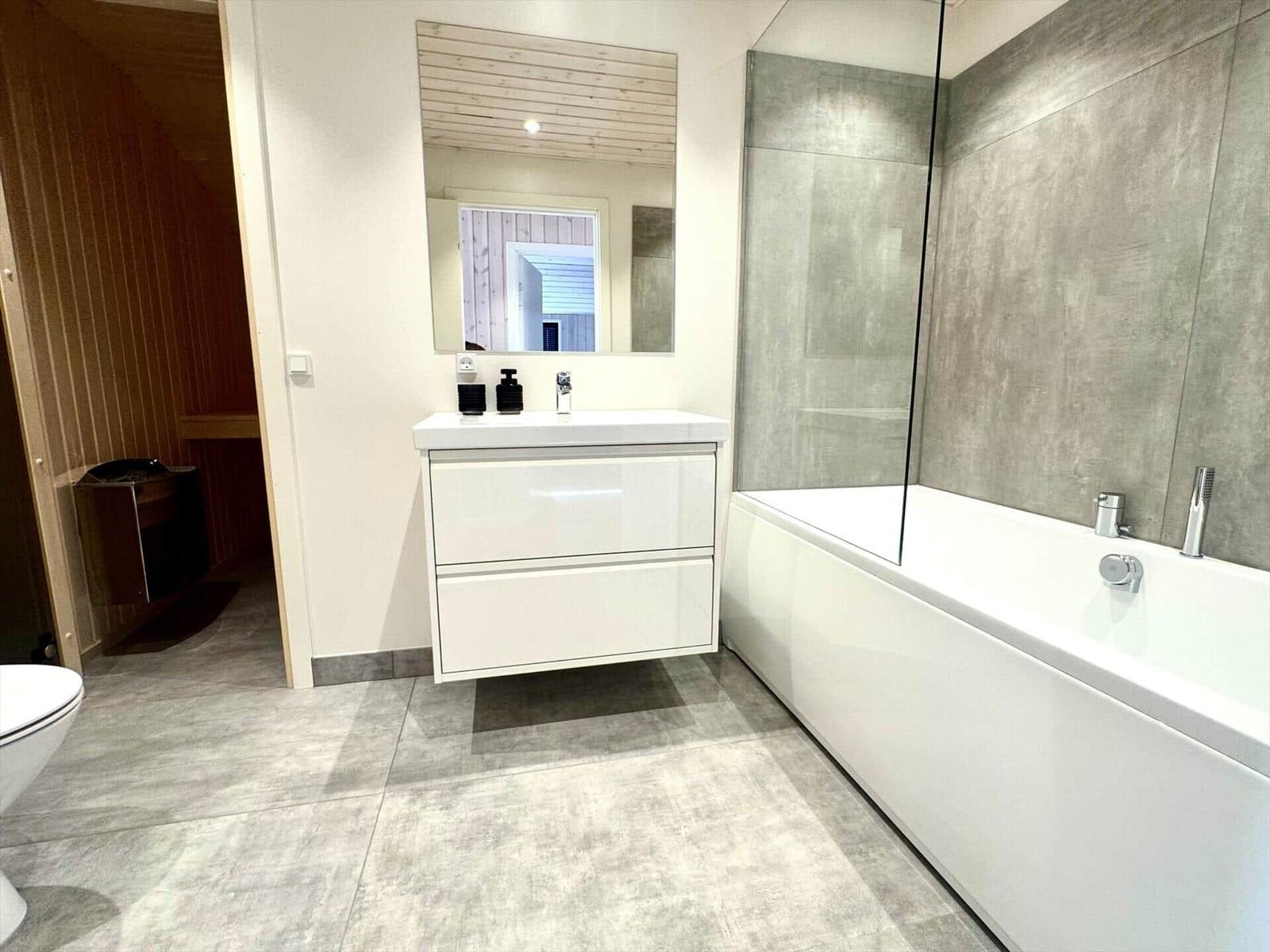 Bathroom with bathtub, shower, and sink