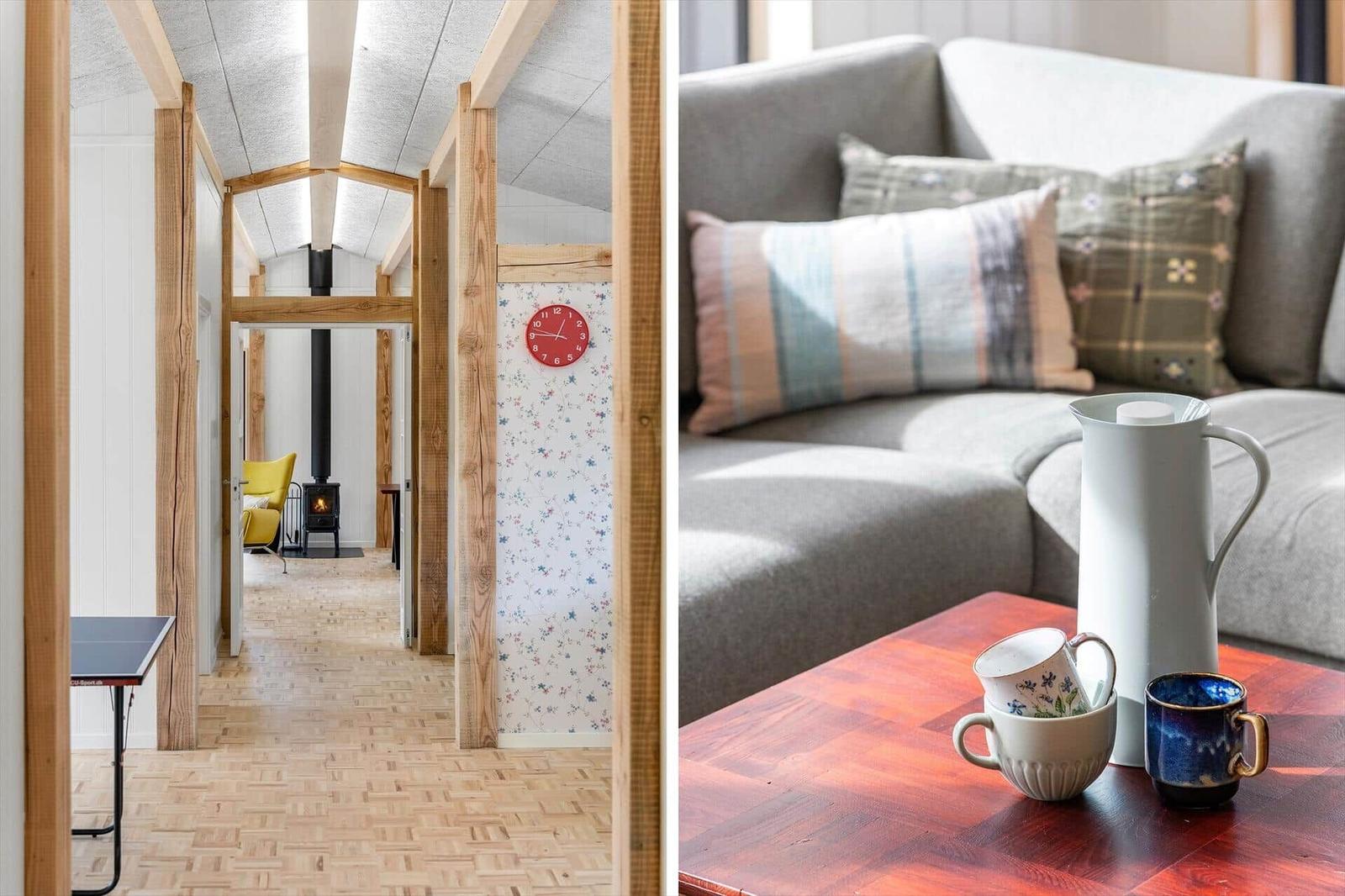 Living area with sofa and table. Hallway with wooden beams and fireplace.