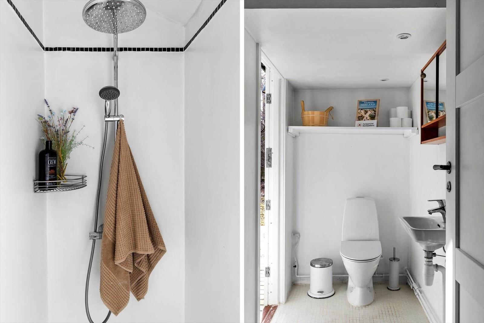 Shower with rain showerhead and brown towel. Toilet and sink with wooden shelf.