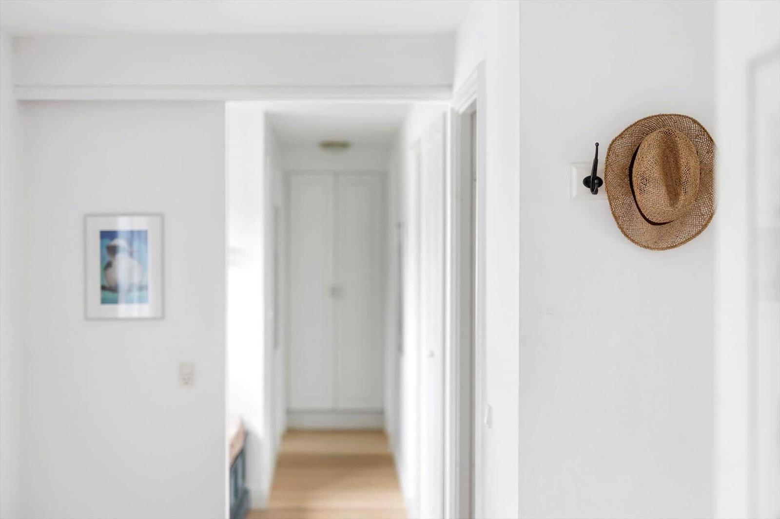 Hallway with straw hat on wall and picture on wall
