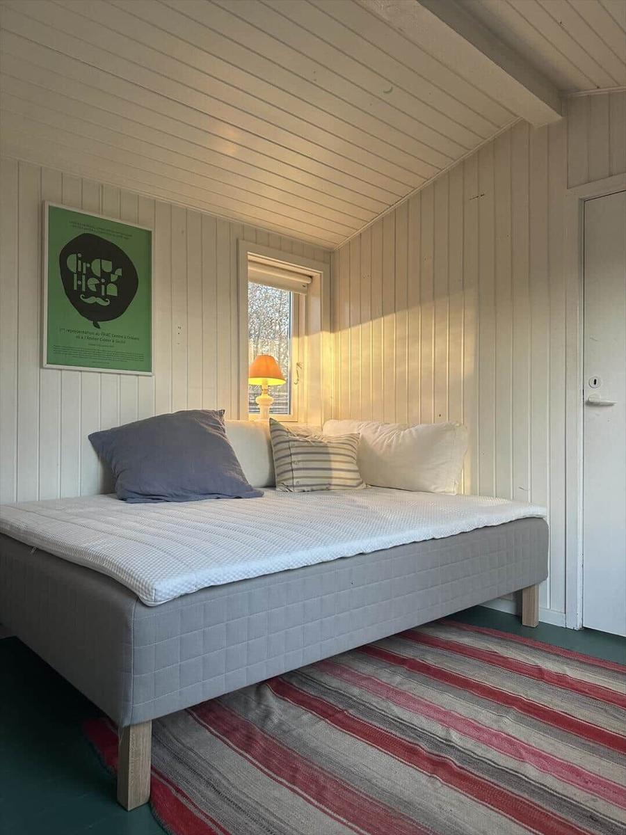 Bedroom with bed, window, and rug