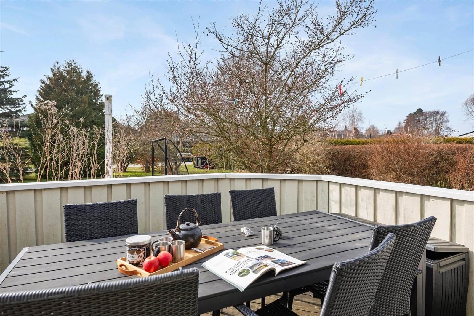 Terrace with table and chairs, tea and magazine ready.