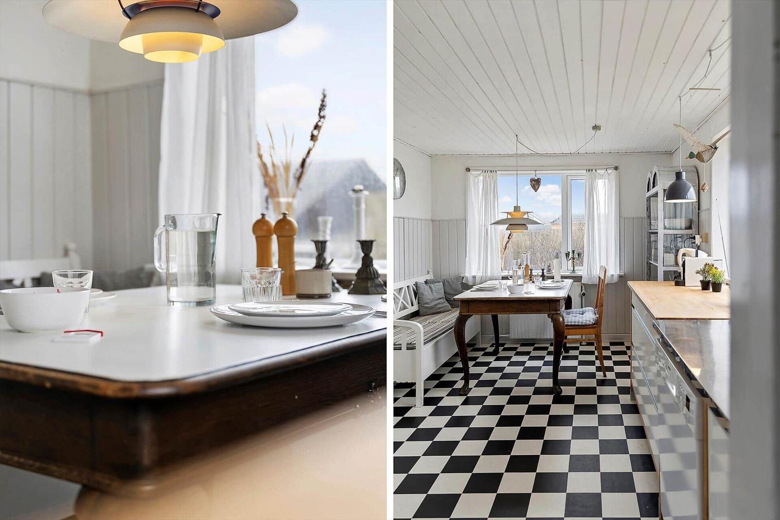 Esszimmer mit schwarz-weißem Boden und Holztisch. Küche mit Arbeitsplatte und Fenster.