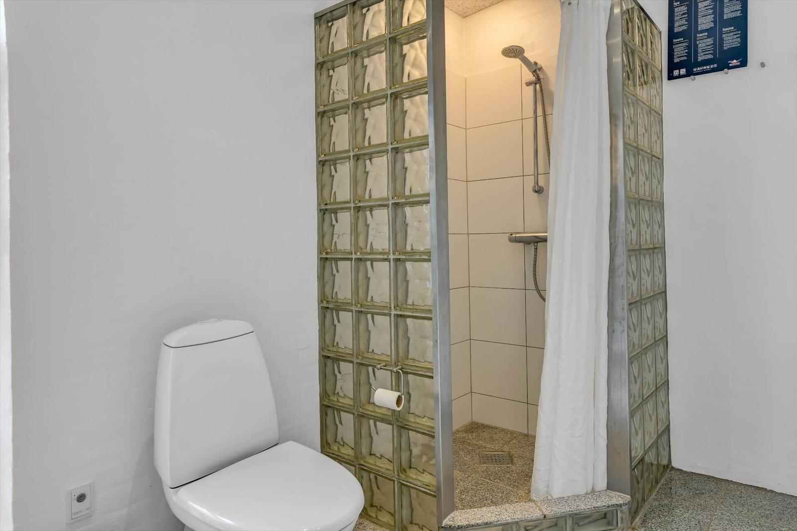Badezimmer mit Toilette und Dusche mit Glasblöcken
