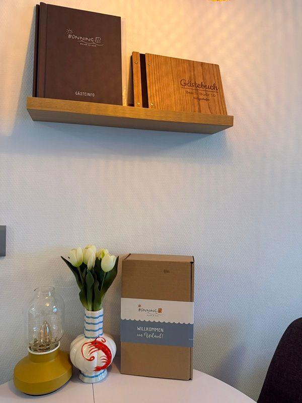 Living area with desk, flowers, and guest books.
