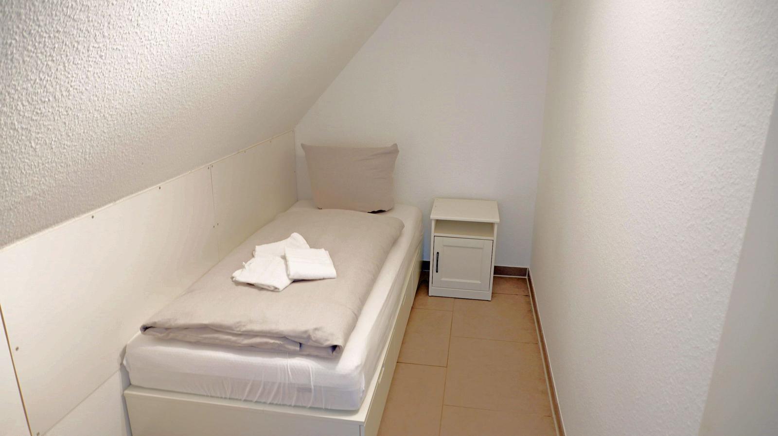 Ein Schlafzimmer mit einem Bett und einem Nachttisch.