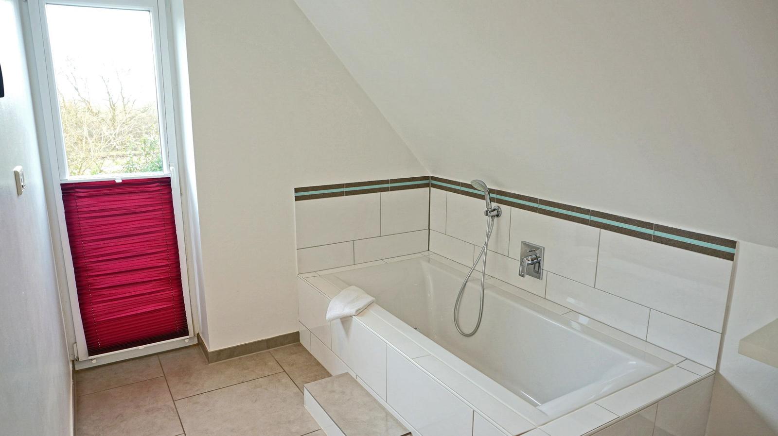 Bad mit Dusche und Fenster mit rotem Jalousie