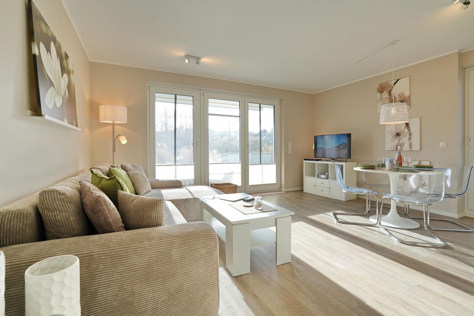 Wohn- und Essbereich mit Sofa, TV und Essplatz.