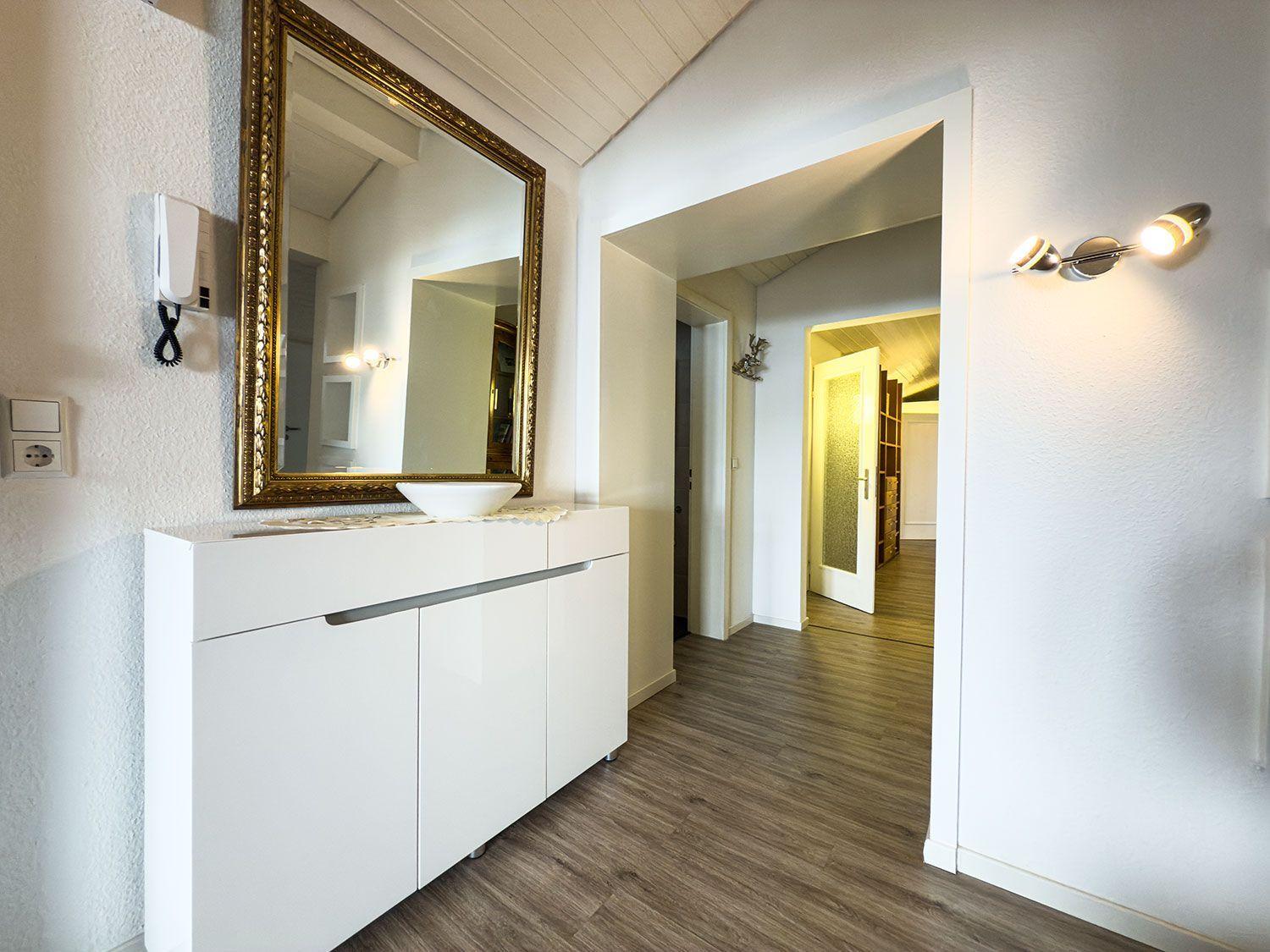Eingangsbereich mit Spiegelschrank und Holzboden
