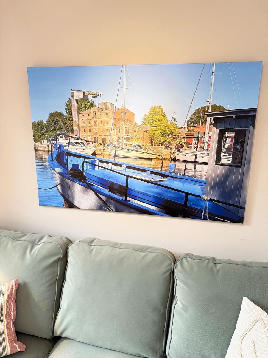 View of harbor with boats and historic buildings on the wall.