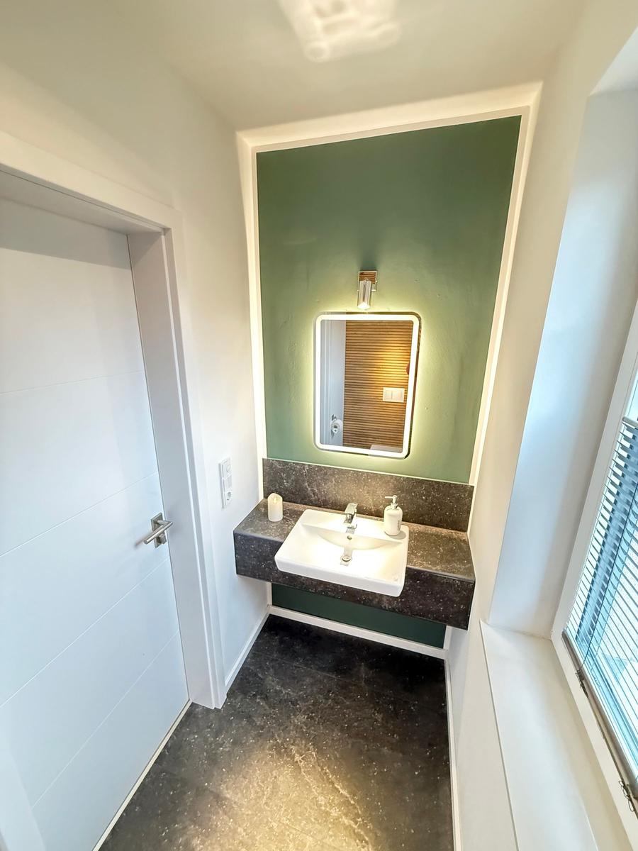 Bathroom with sink, mirror, and window