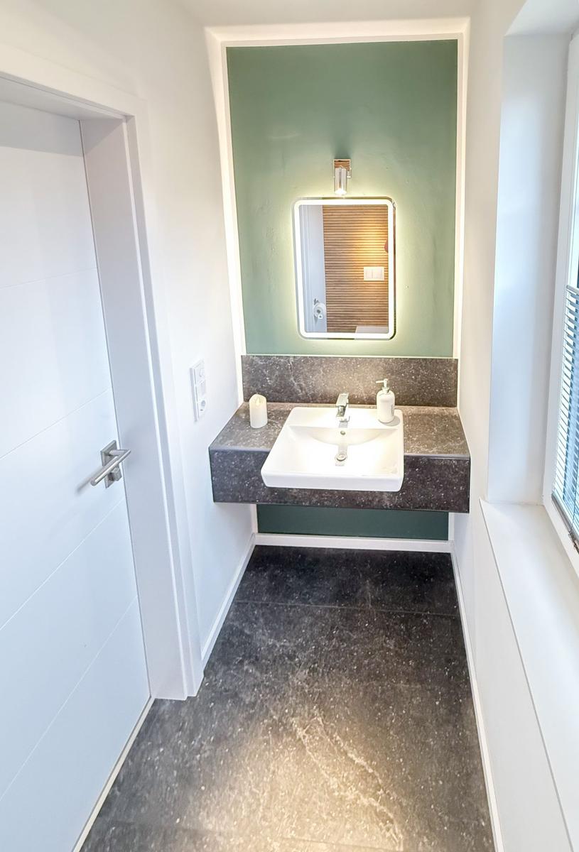 Bathroom with sink, mirror, and window