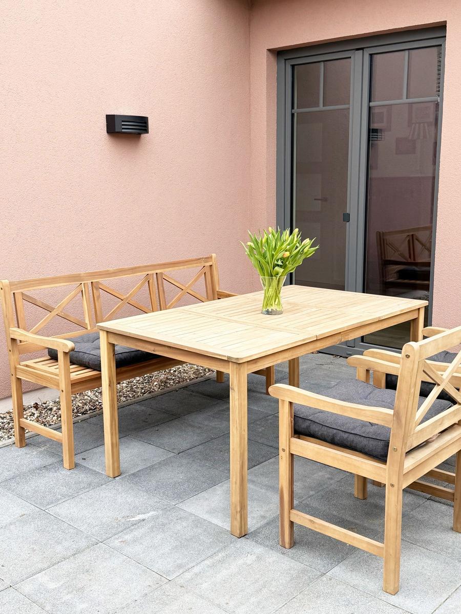 Terrace with wooden table, benches, and flowers