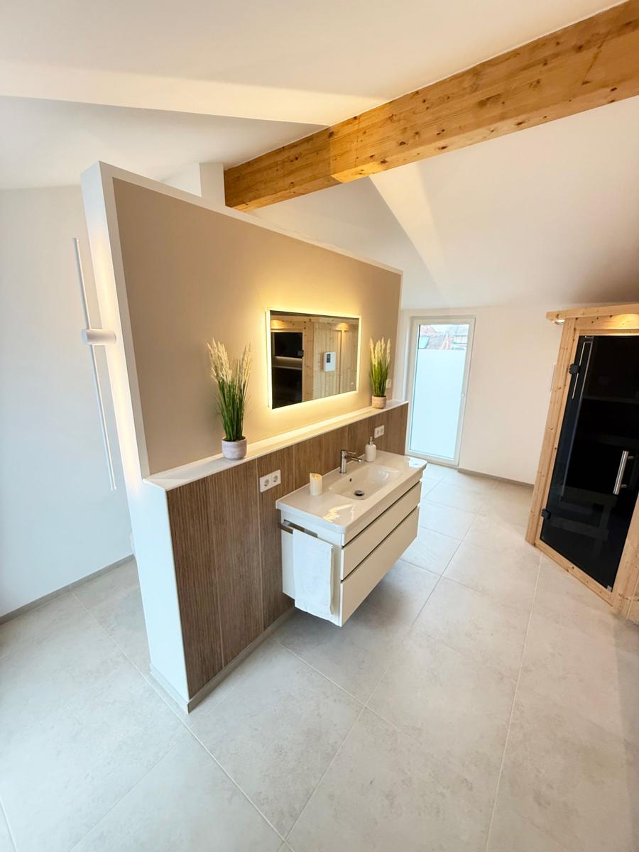 Bathroom with sink, mirror, and sauna