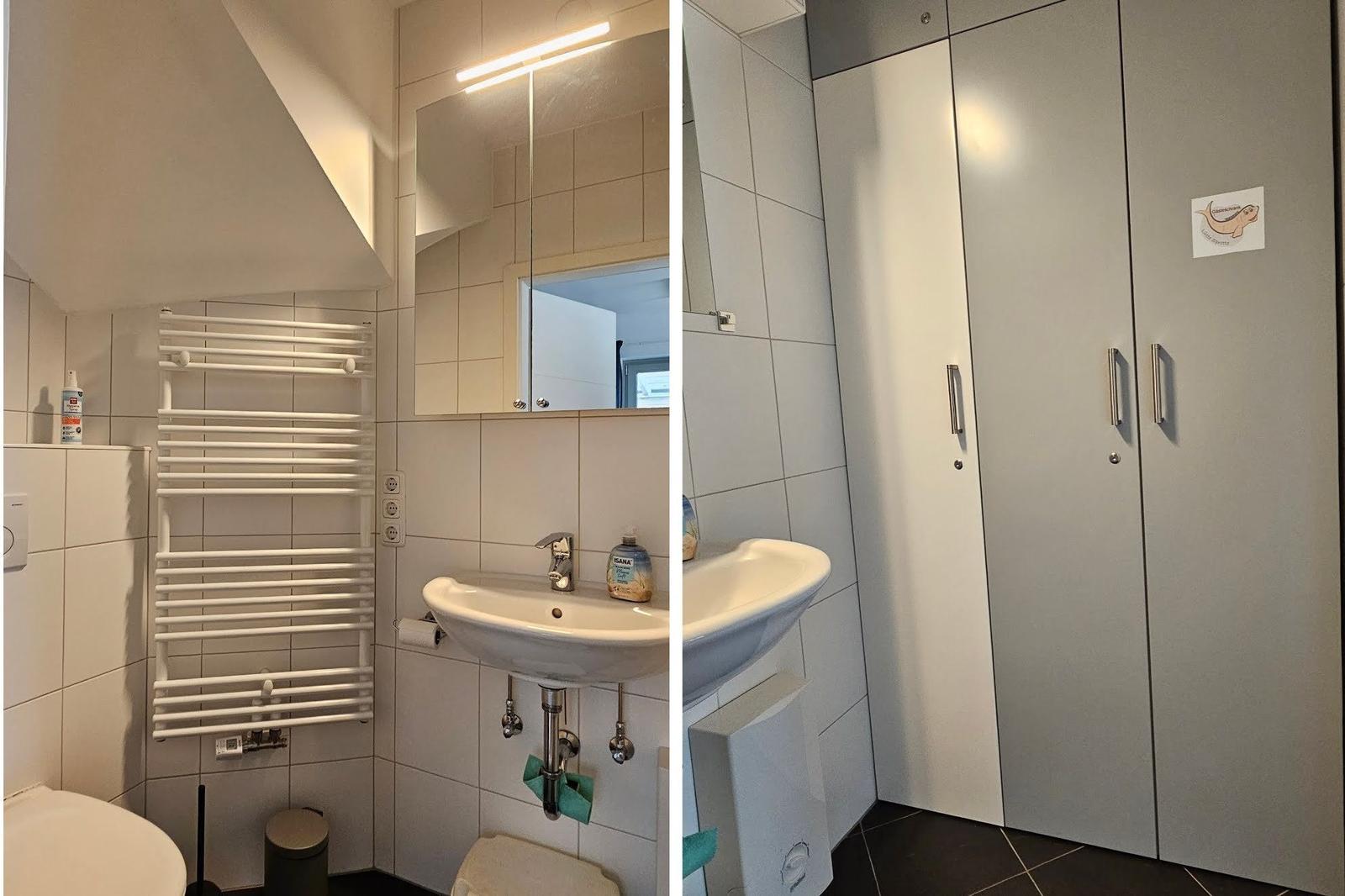 Badezimmer mit Waschbecken, Spiegel und Heizkörper. Nebenraum mit Schrank und Waschbecken.