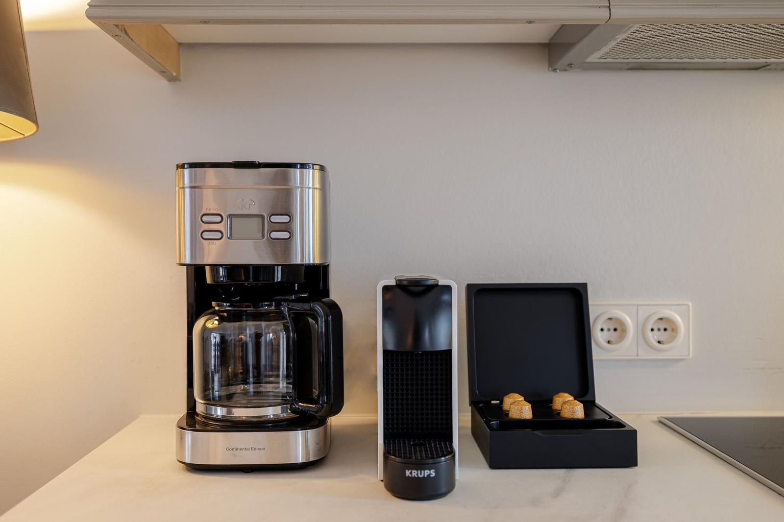 Kitchen area with coffee maker and Nespresso machine.
