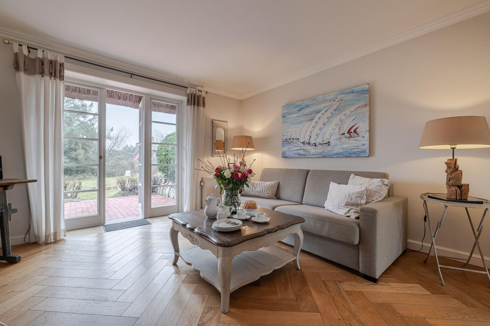 Living room with sofa, table, and view of garden