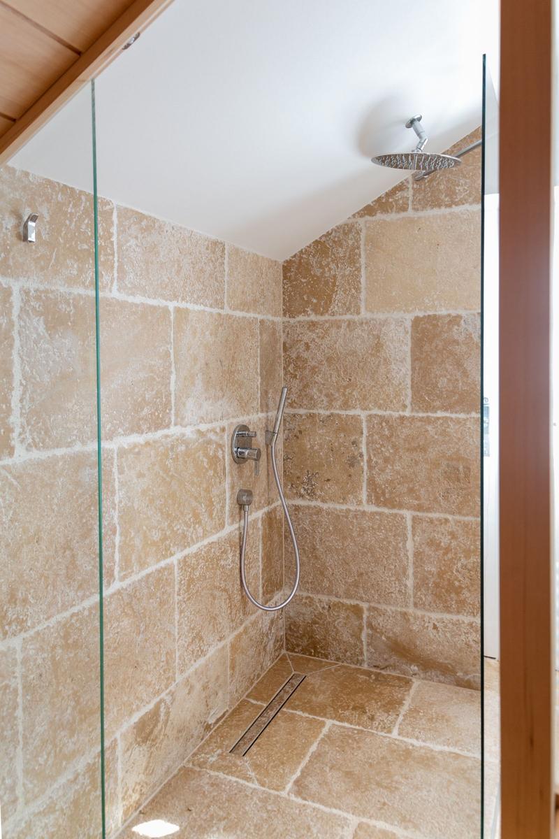 Shower with stone walls and shower head