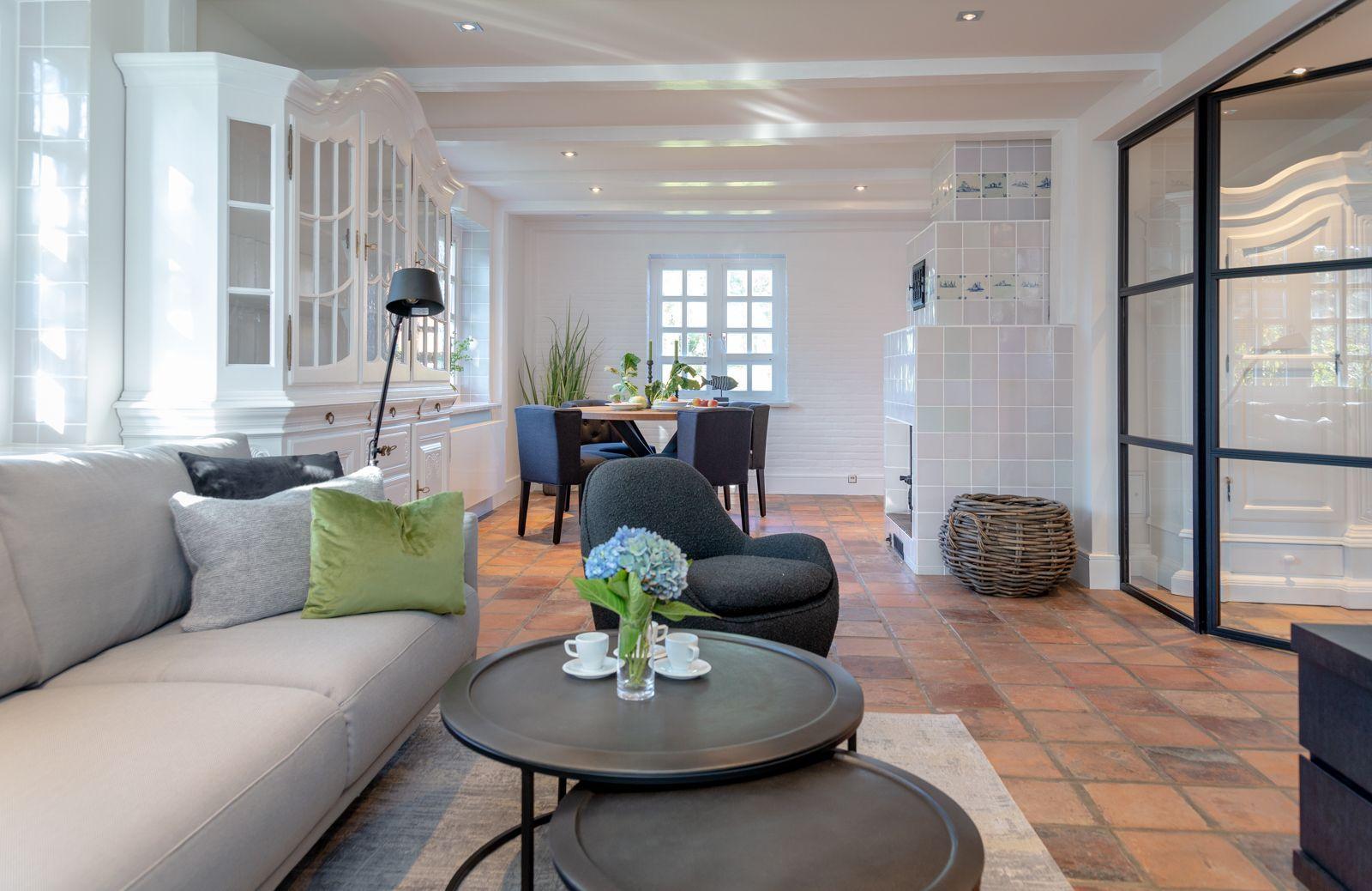 Living and dining area with sofa, table, and fireplace.