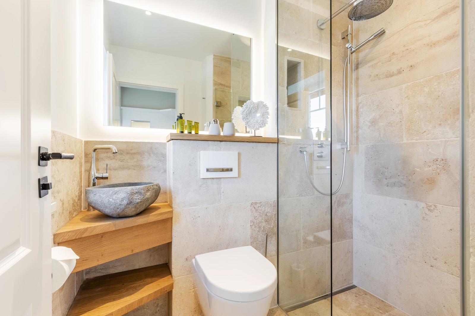 Bathroom with shower, sink, and toilet