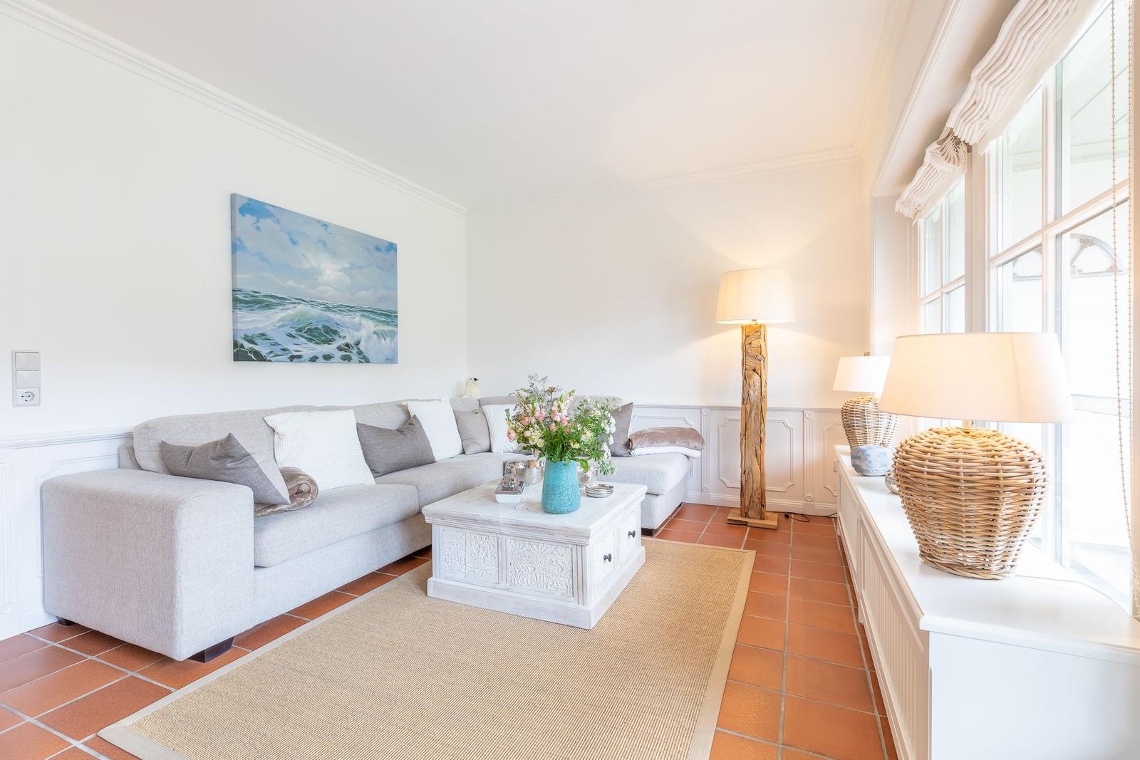 Living room with sofa, coffee table, and window