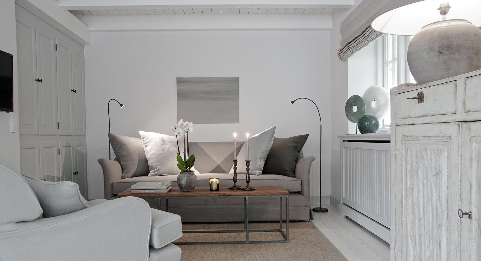 Living room with sofa, coffee table, and white cabinets.