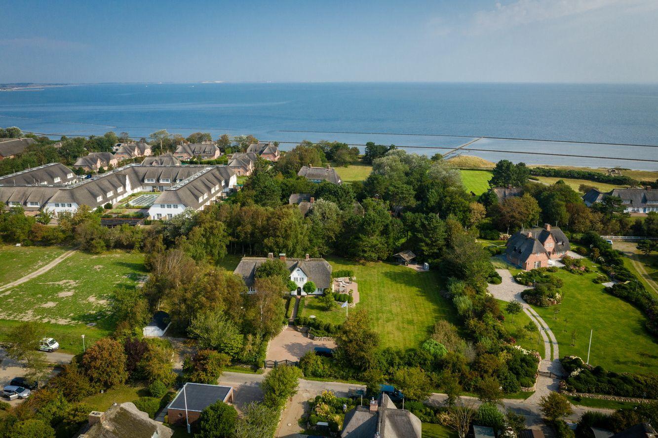 View of coastal town with houses and green areas