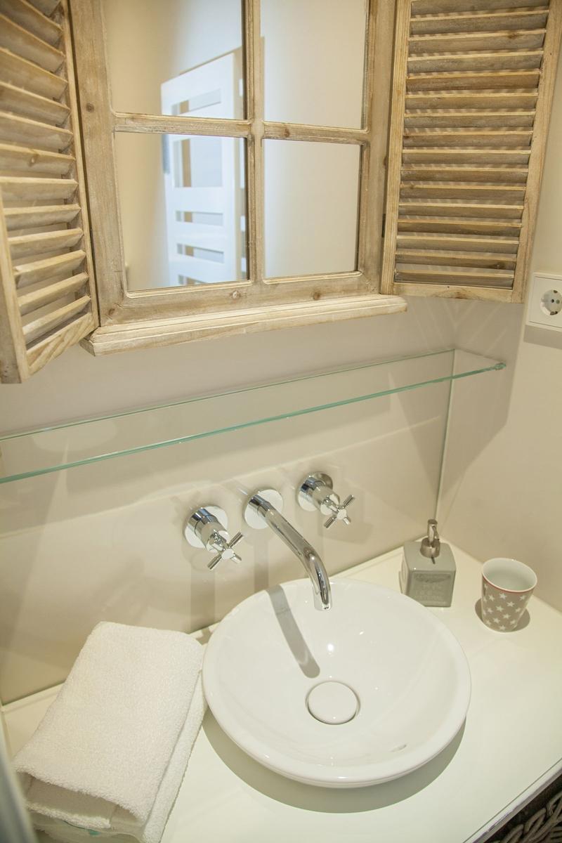 Bathroom with sink, mirror, and towel