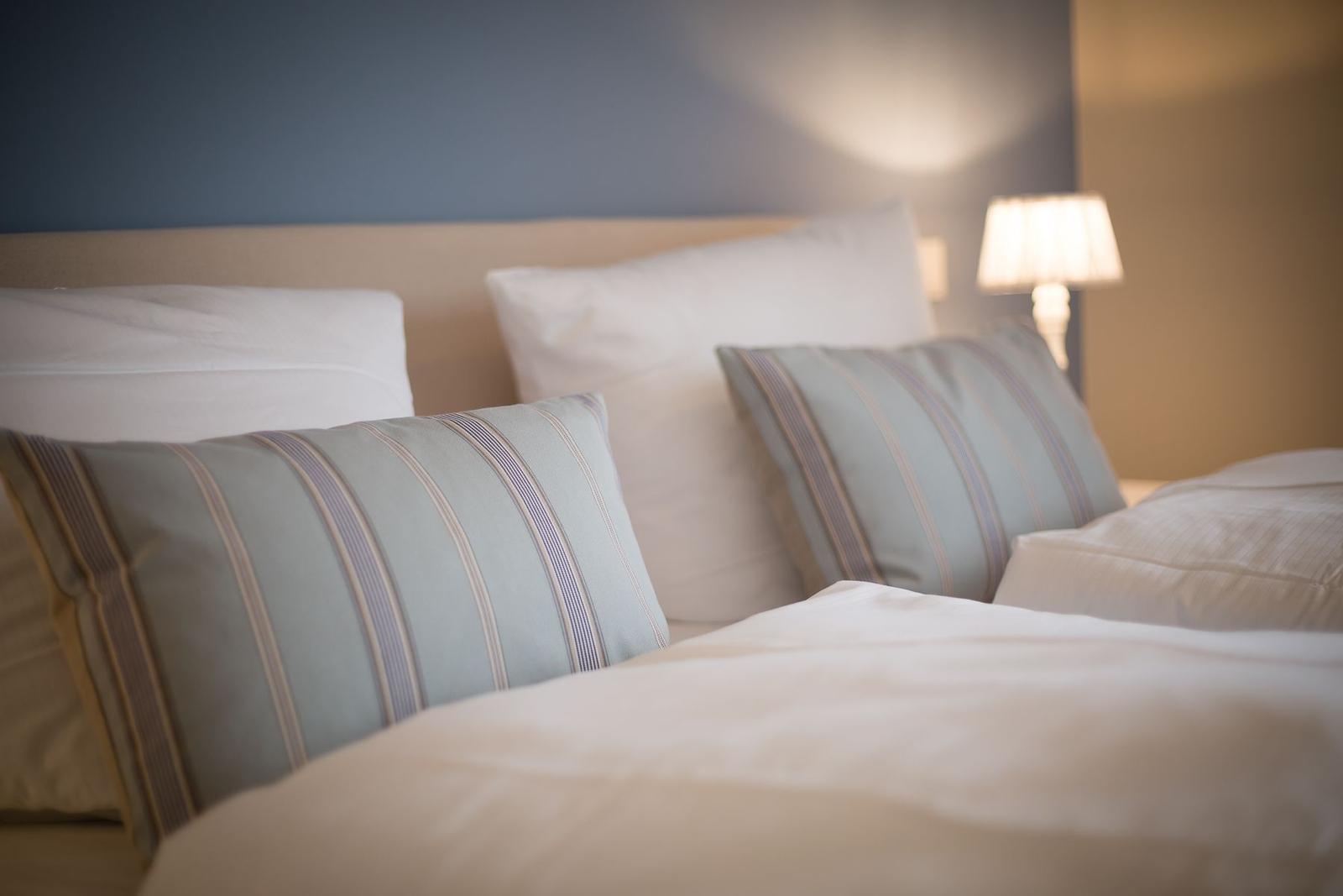 Bed head with pillows and bedside lamp