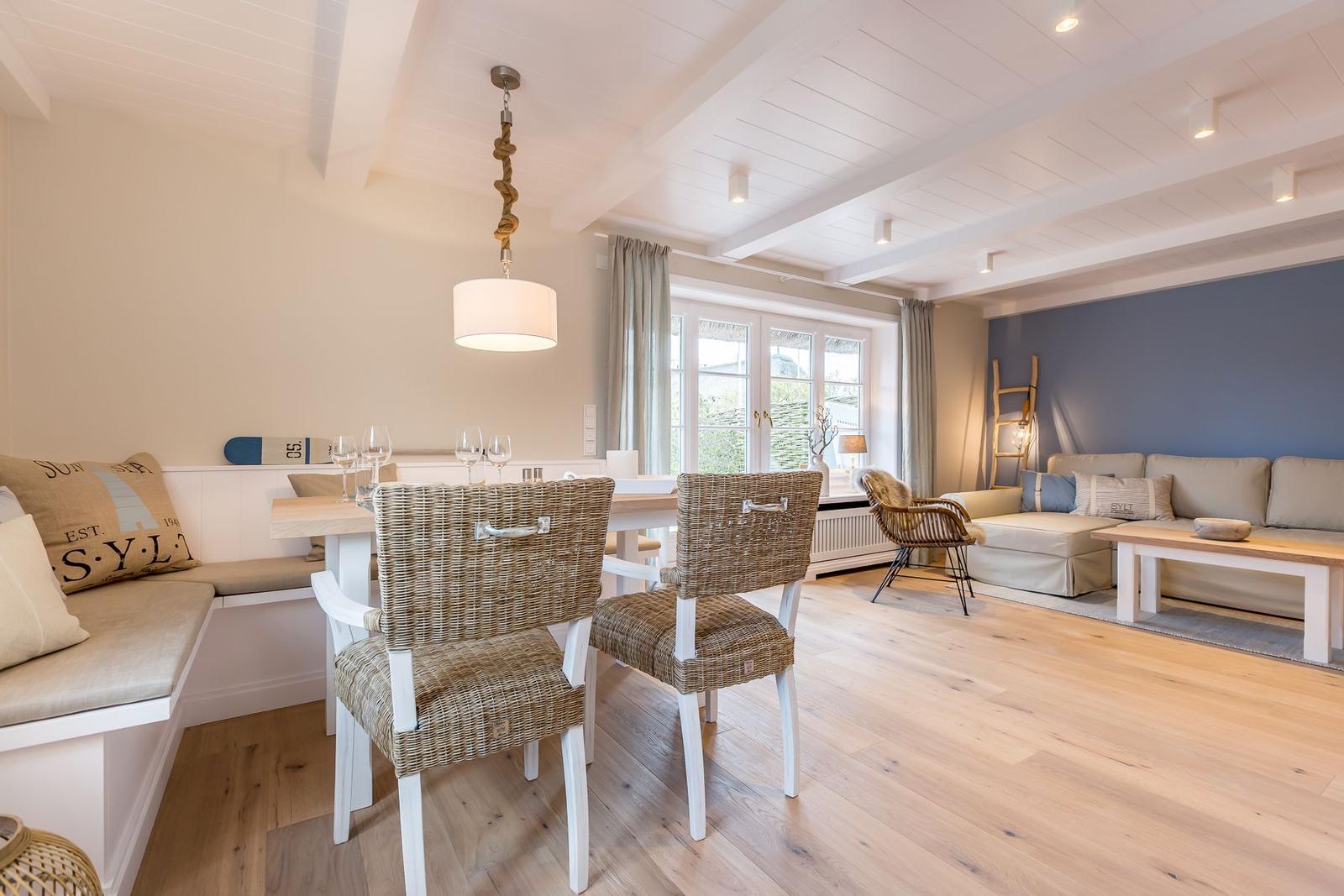 Dining area with bench and table. Living area with sofa and coffee table.