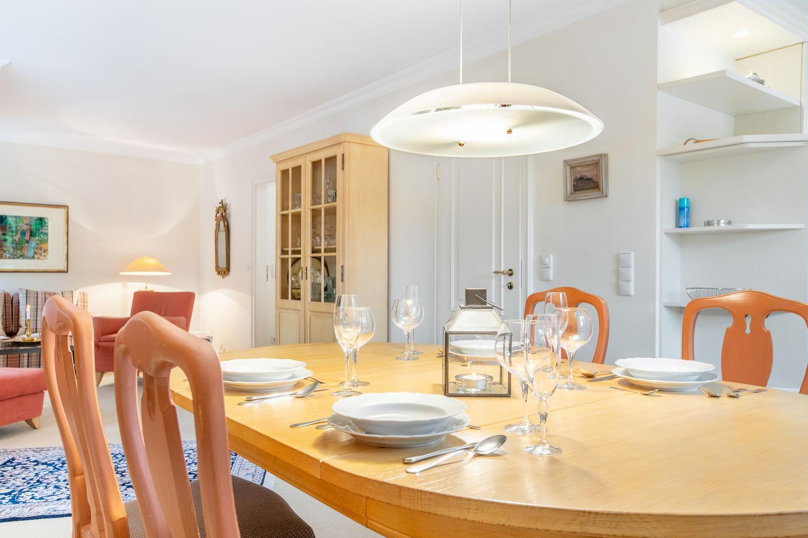 Dining table with chairs and dishes in dining room