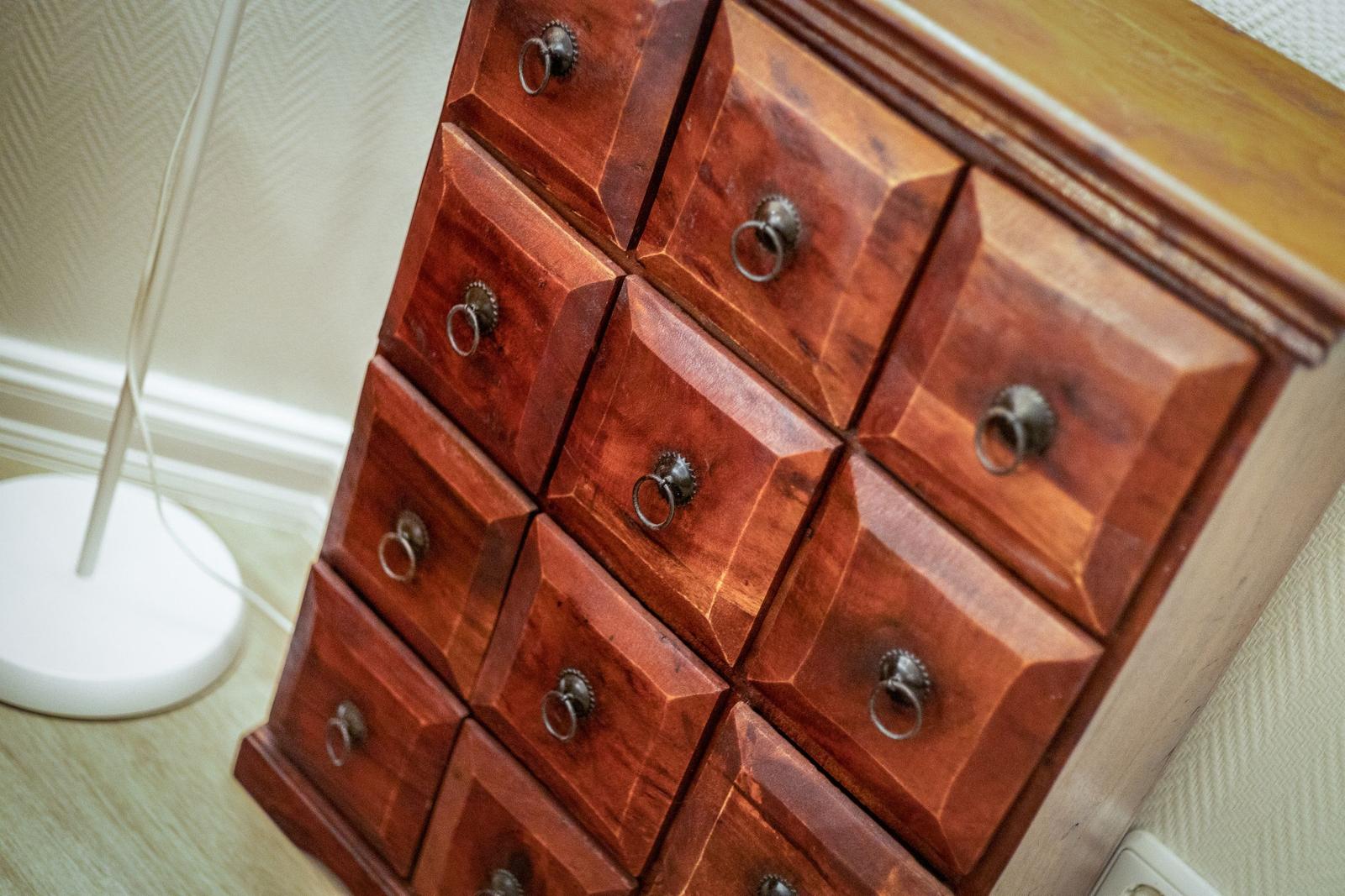 Wooden cabinet with nine drawers and metal handles