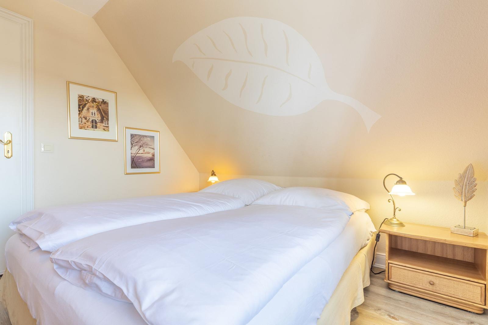 Bedroom with double bed, nightstand, and wall mural