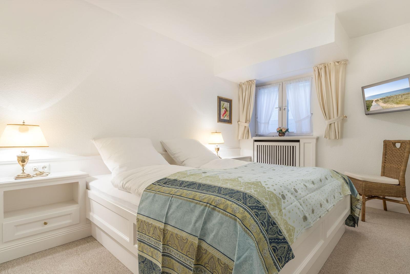 Bedroom with bed, nightstand, and window