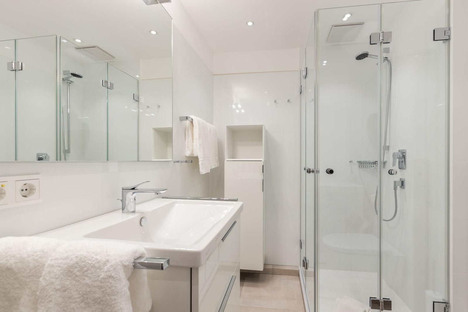Bathroom with shower, sink, and mirror