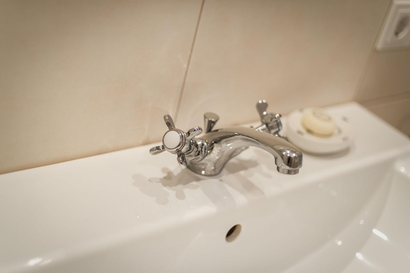 Sink with chrome faucet and soap dish