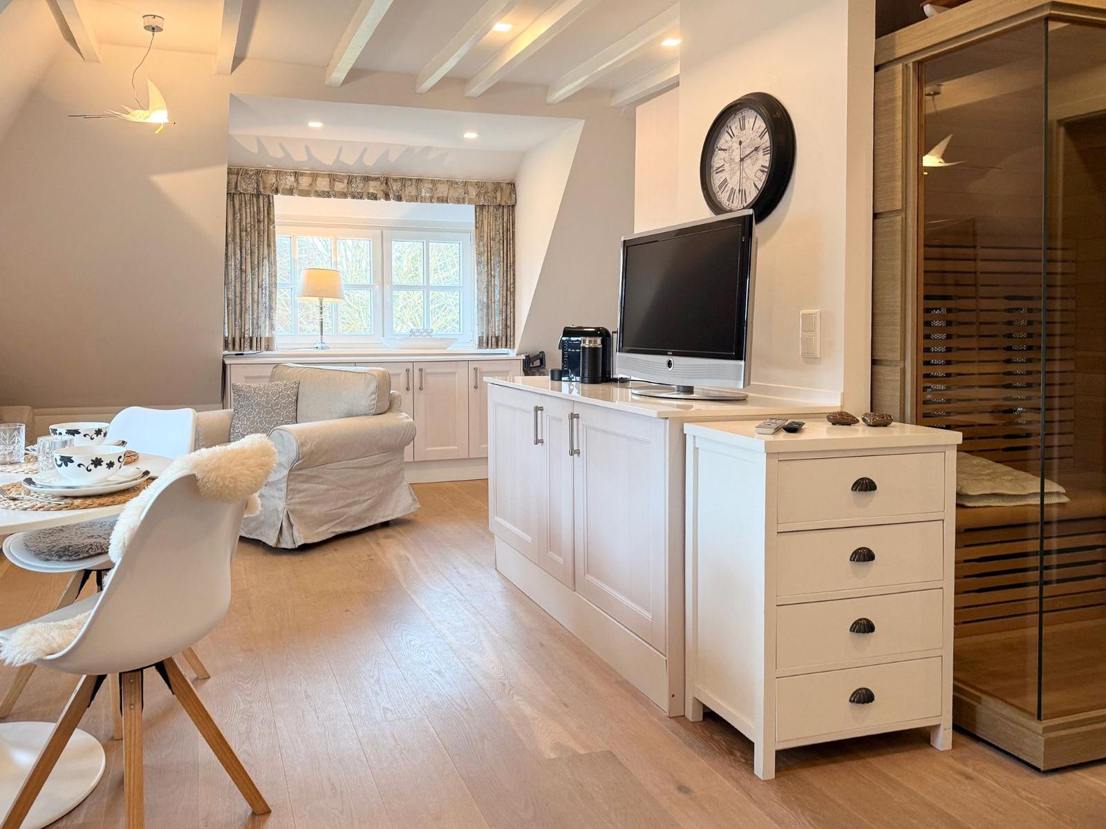 Living and dining area with sauna and TV.