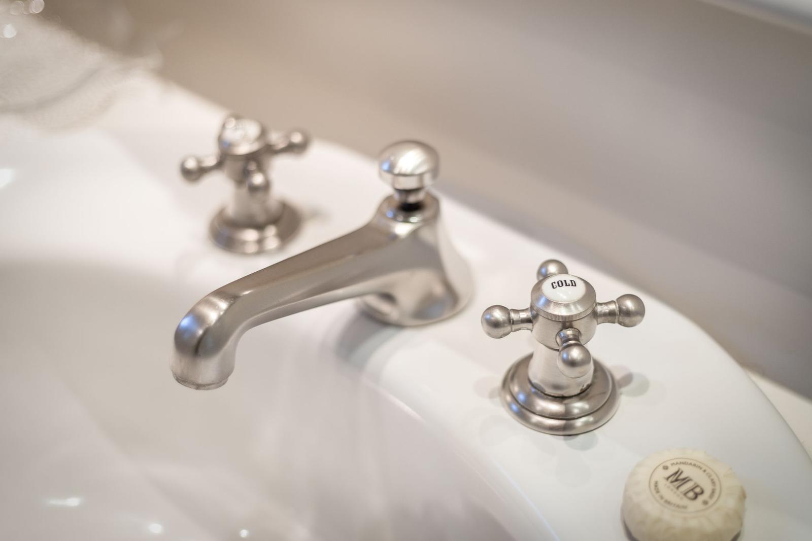 Sink with silver faucets and soap
