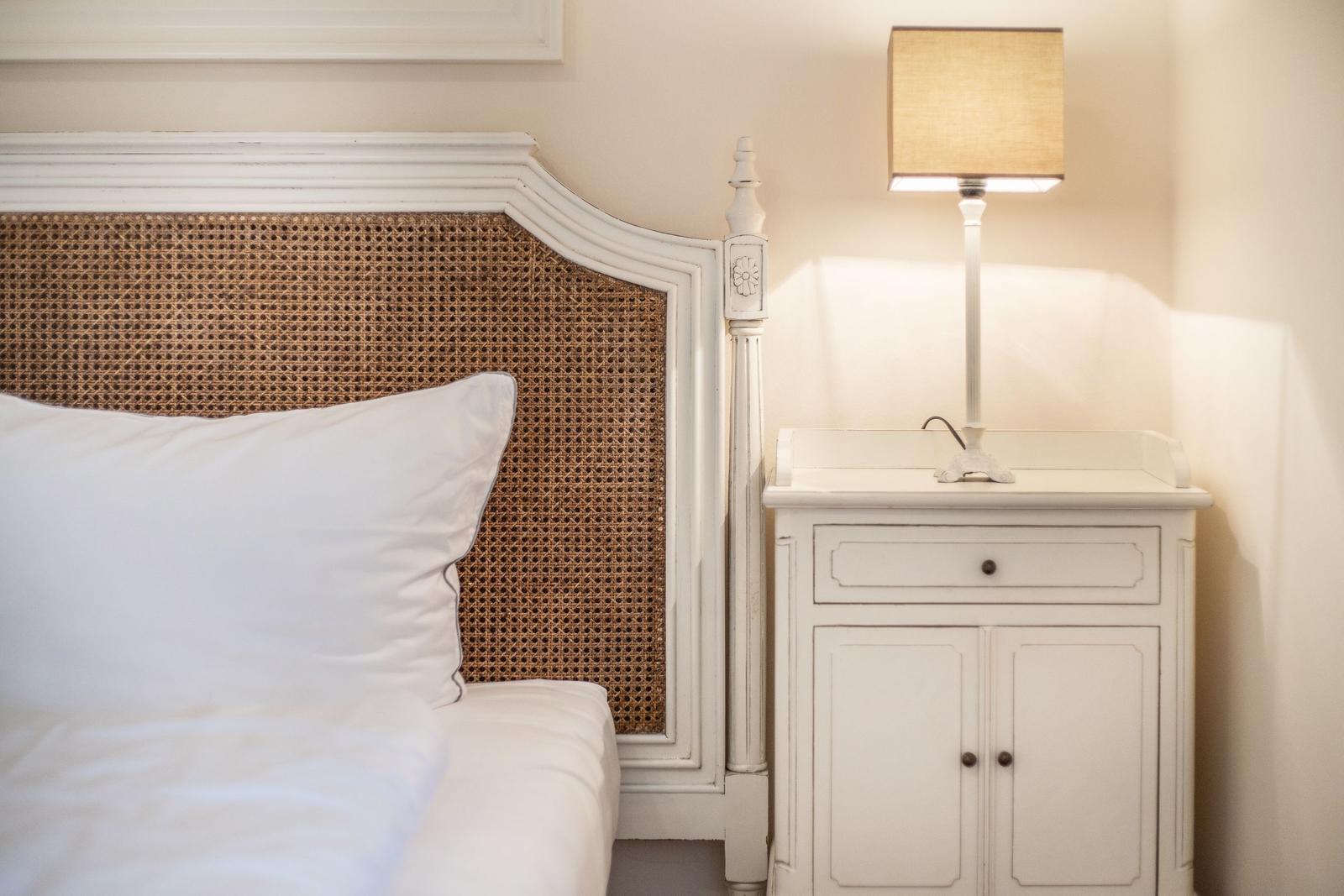 Bed headboard with rattan, nightstand and lamp