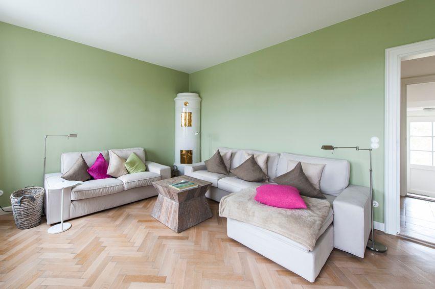 Living room with two sofas, table, and wooden floor.