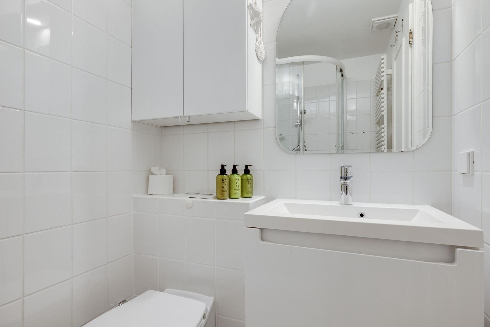 Bathroom with sink, mirror, and shower