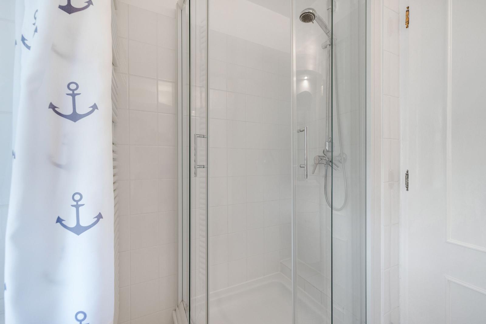 Shower with glass enclosure and hook on door