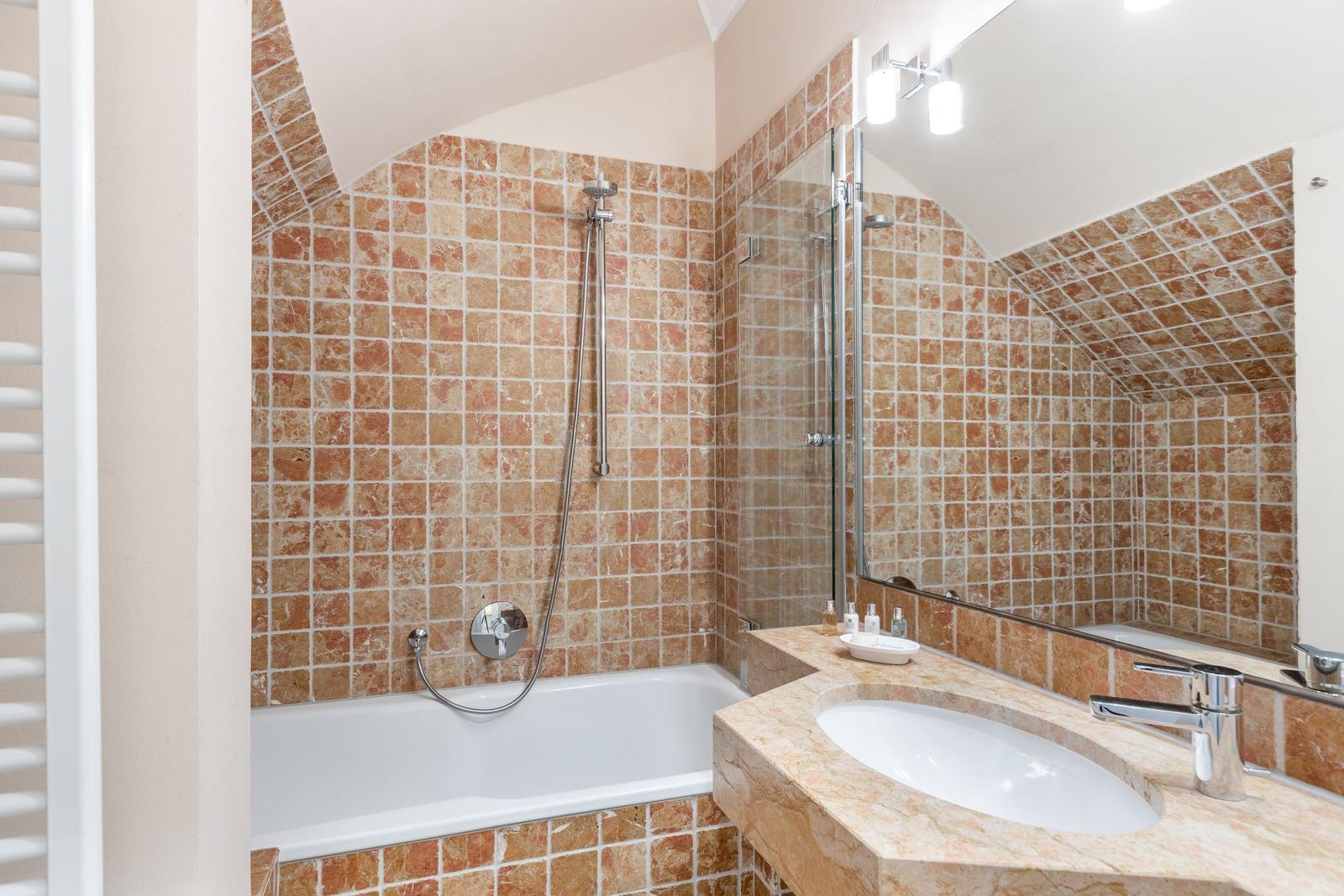 Badezimmer mit Badewanne, Dusche und Waschtisch