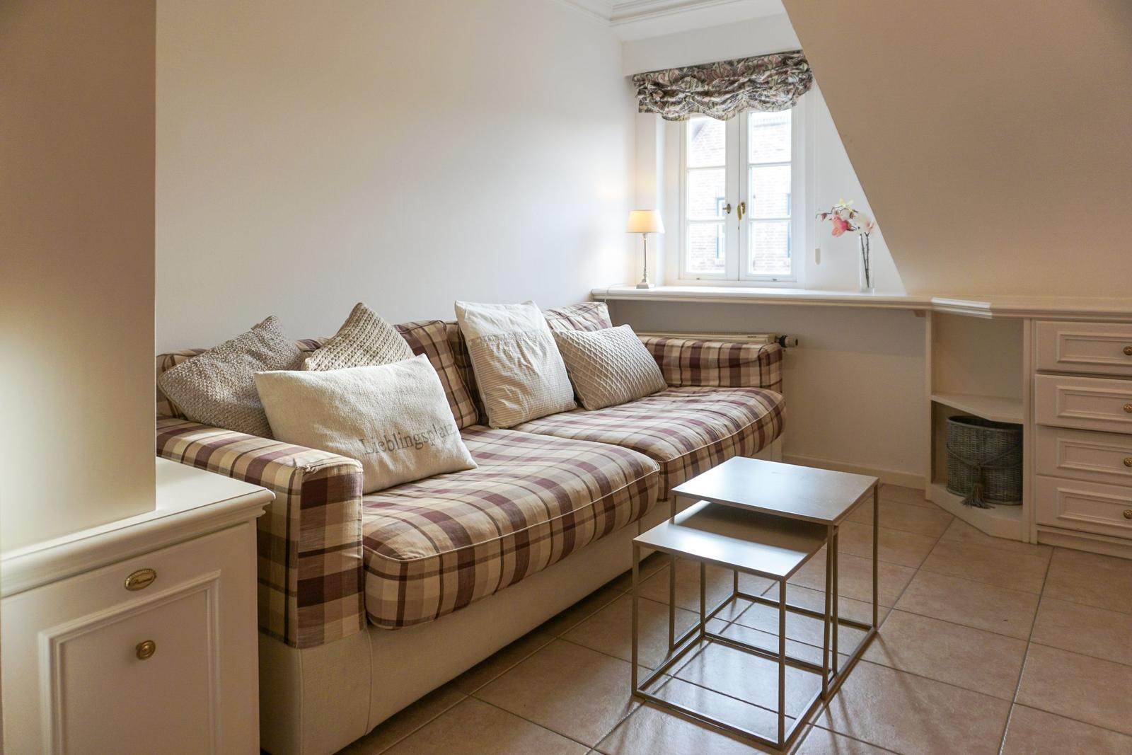 Living room with sofa, table, and window