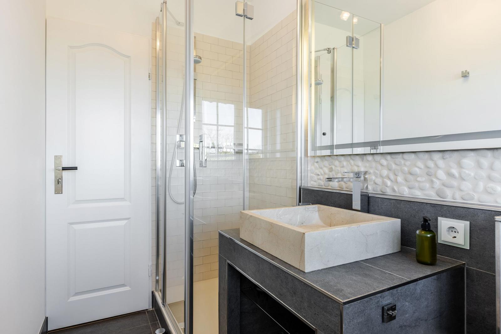 Bad mit Dusche, Waschbecken und Spiegelschrank
