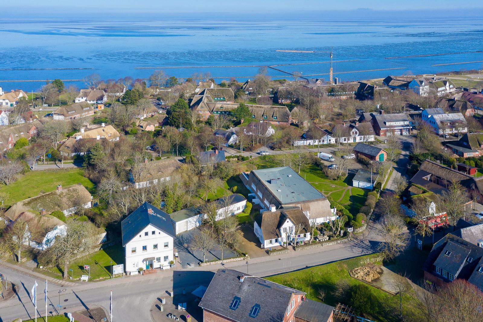 Houses with roofs and green areas by the water