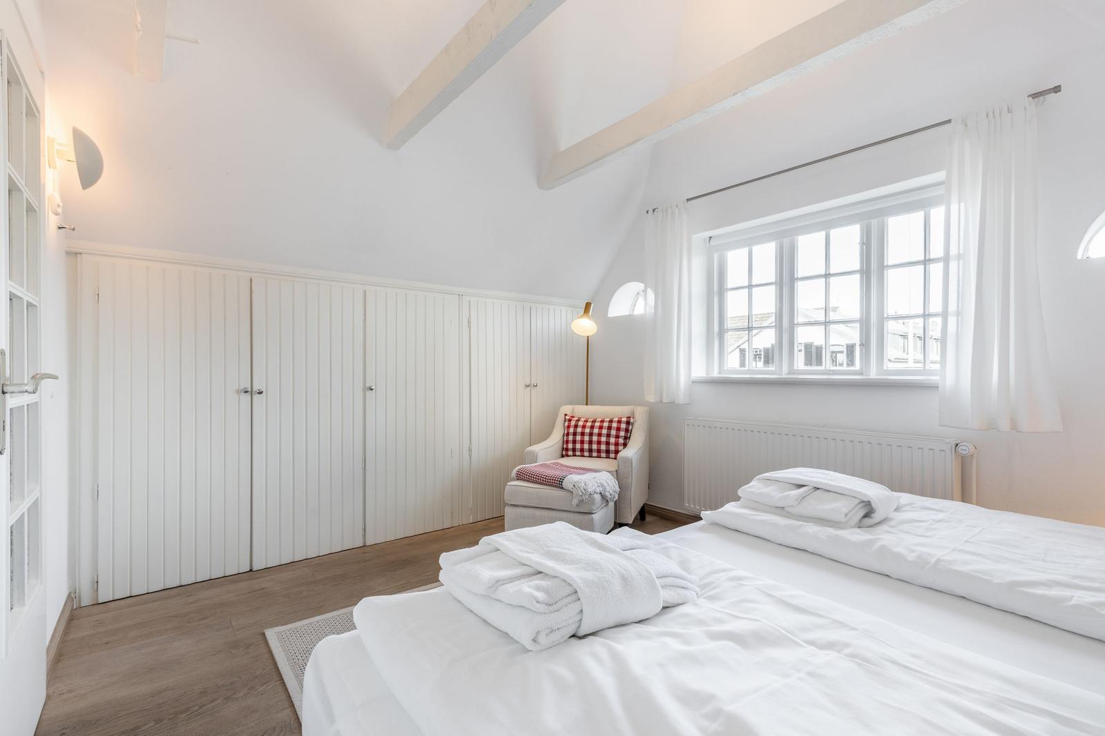 Bedroom with bed, closet, and window