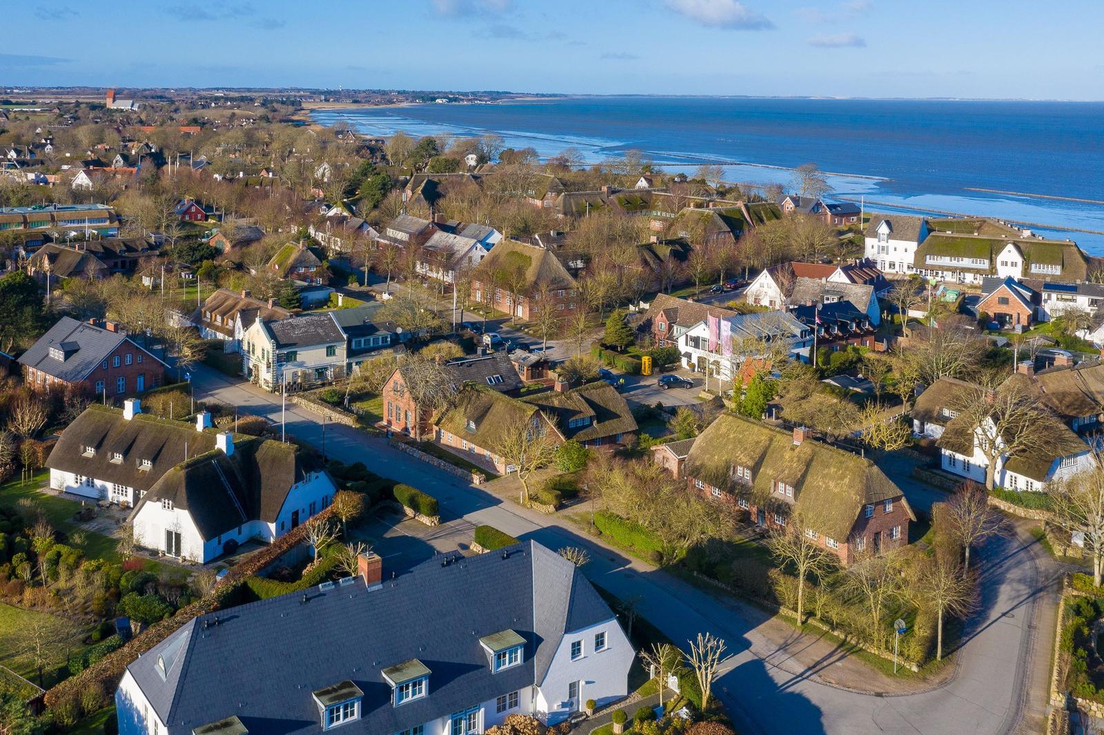 Village with traditional houses and view of the sea