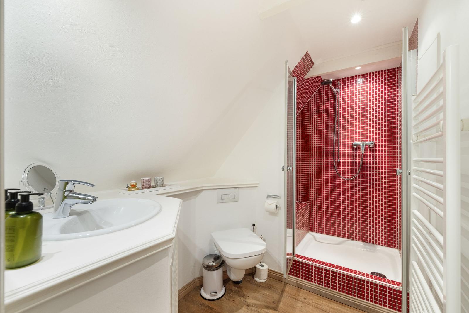 Bathroom with shower, sink, and toilet