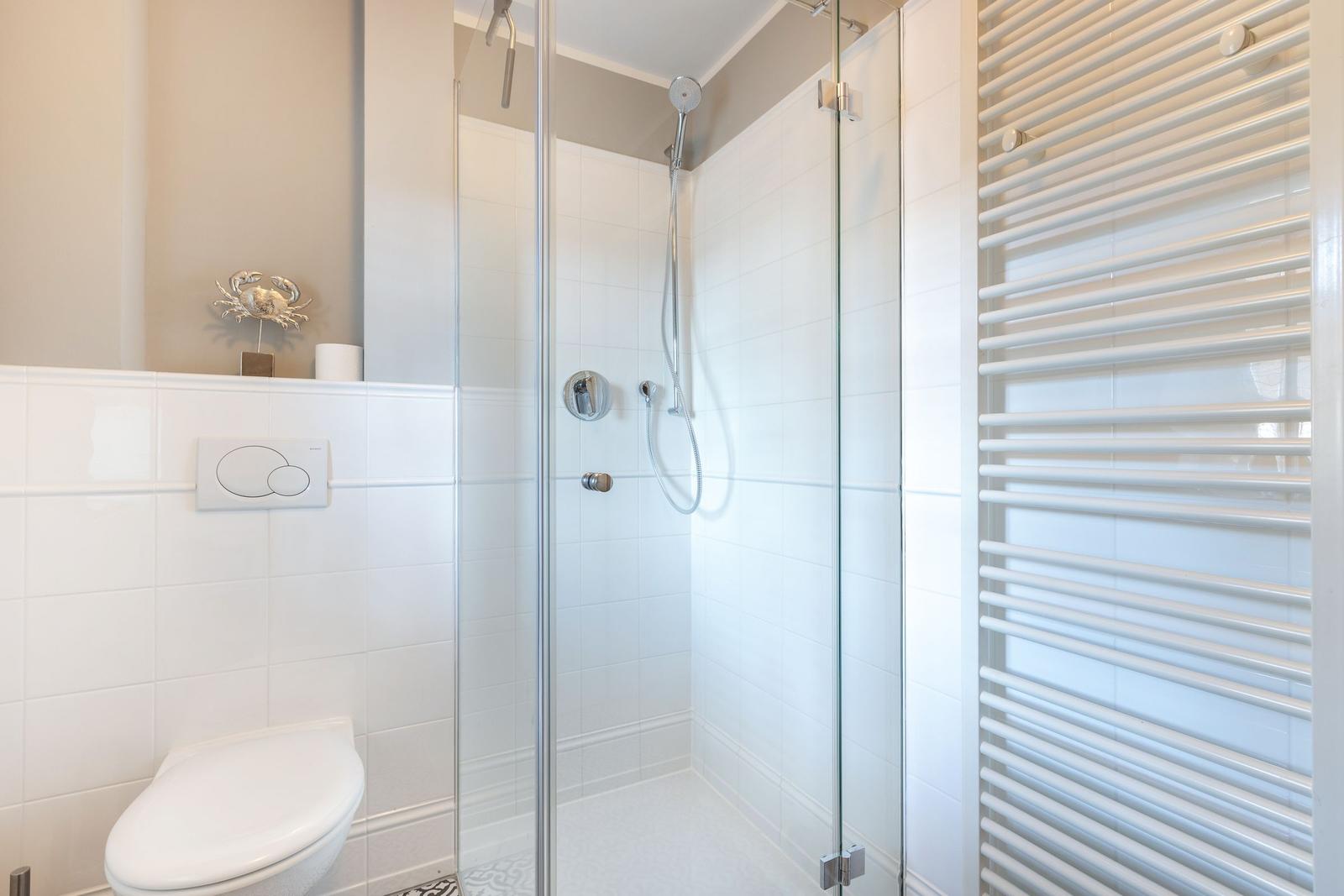 Bathroom with shower, toilet, and heater